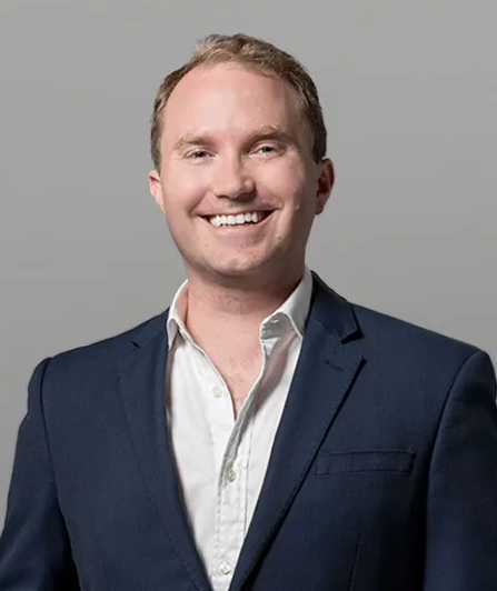 Headshot photo of Grant Passmore. White male in business suit.